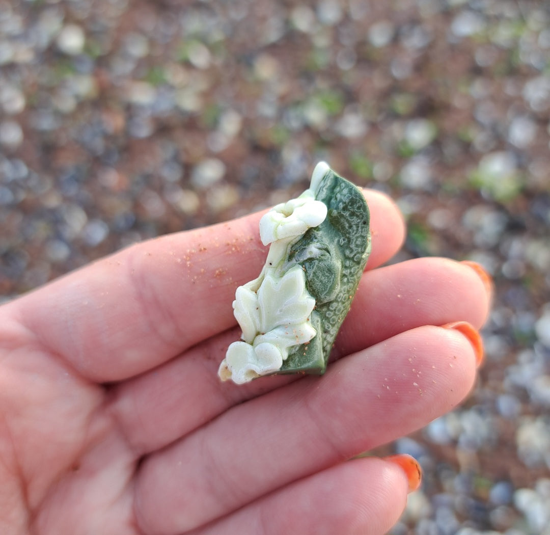 Green Pottery Fragment with White Floral Detail